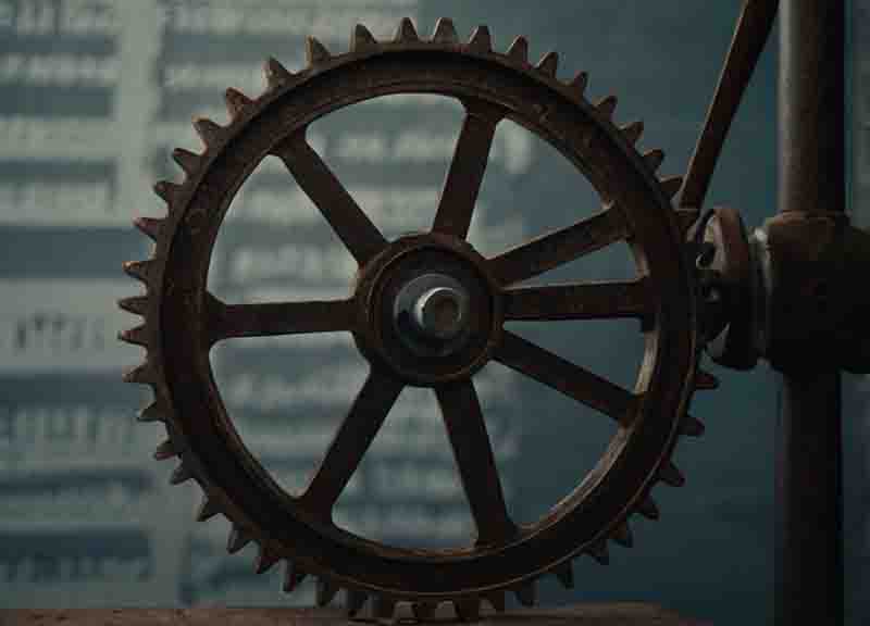 A close-up view of a clock showcasing intricate gears and mechanisms, highlighting the precision of BRICS.